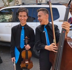 Photo of 2 students with string instruments.